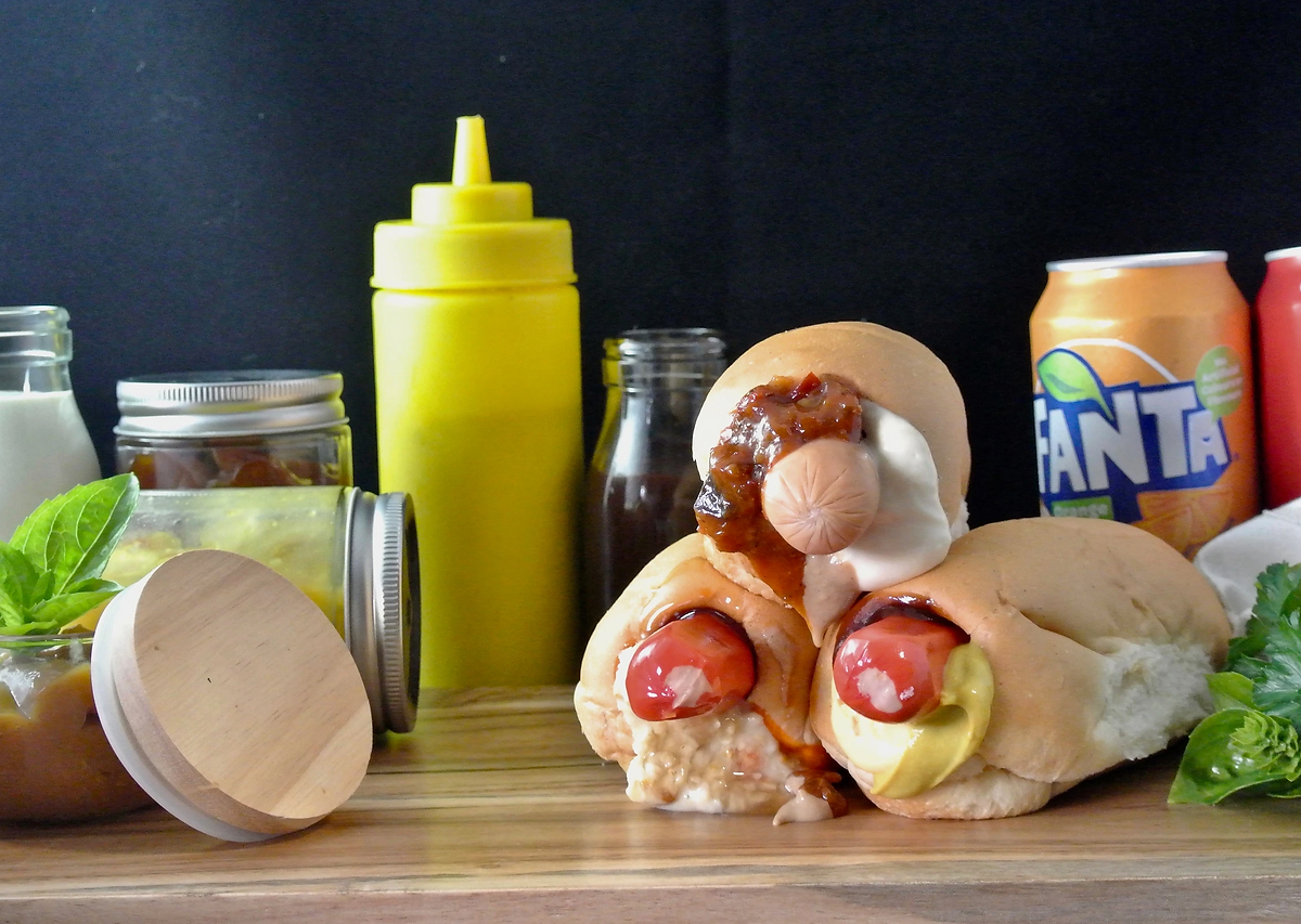 Gourmet hot dogs on the bench with artisan sauces
